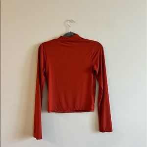 Size M. Burnt orange long sleeve, high neck top.